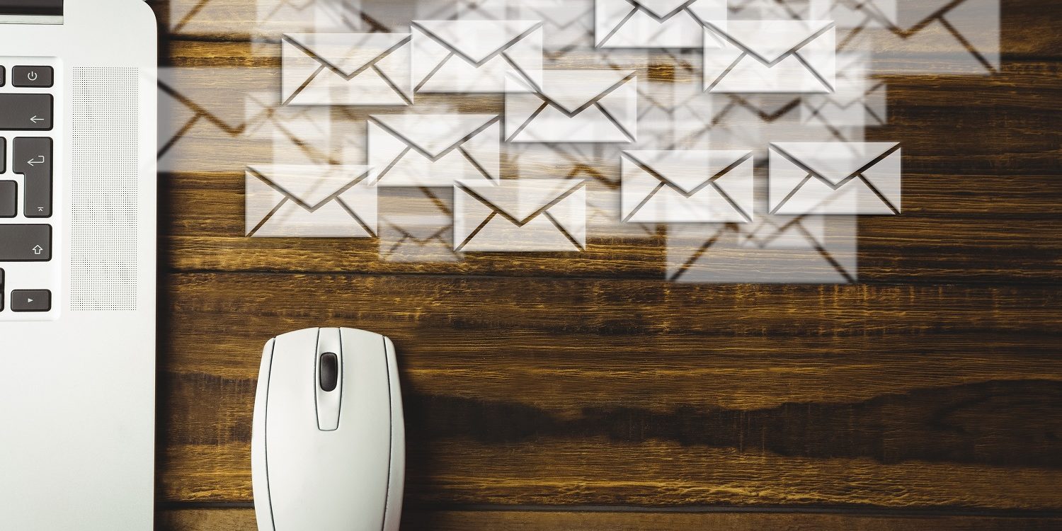 Composite image of laptop and mouse put on a desk with letter icons Is online faxing more secure than email?